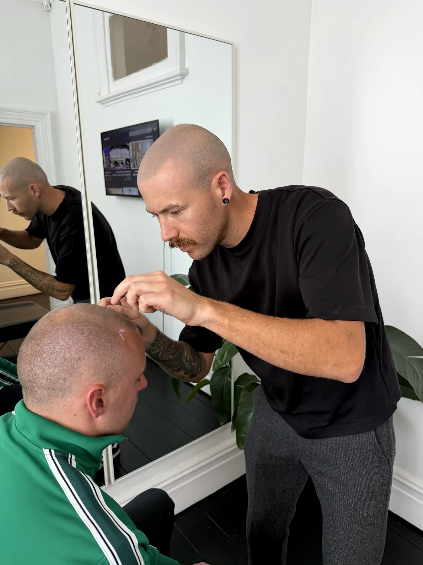Taylor working on a client in the Chapel Street studio